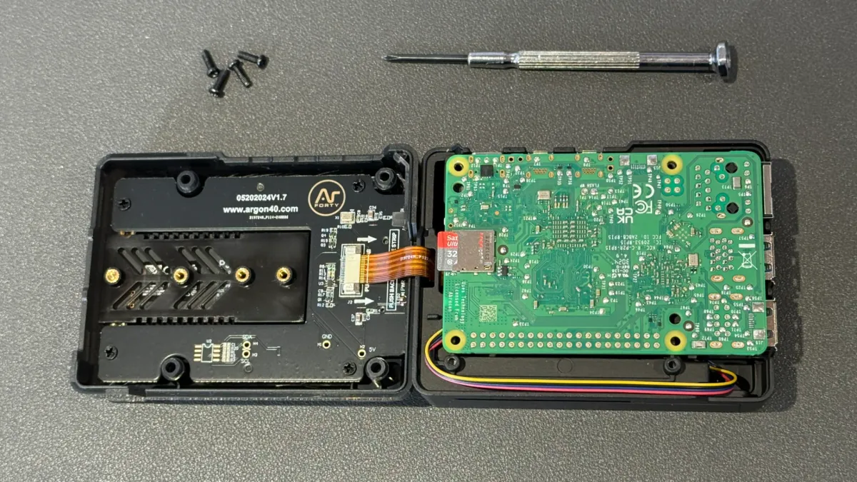 Ribbon cable from the Pi attaches to the Argon Neo 5 NVMe base board.