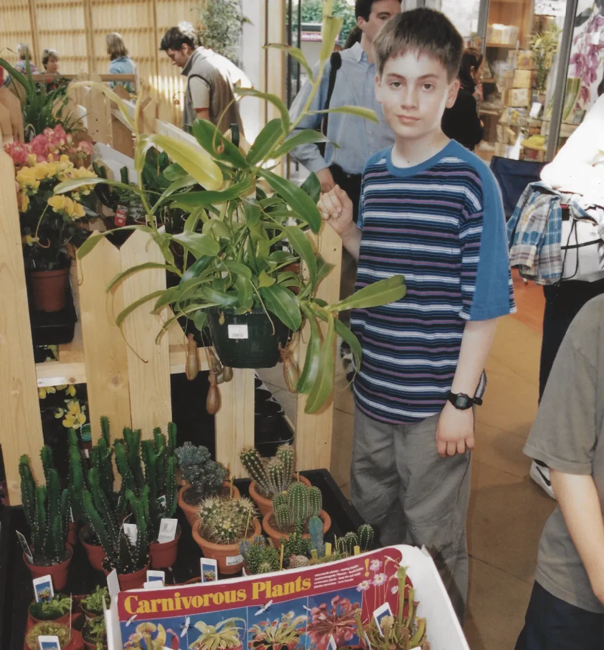 The author at Kew Gardens, circa 1901, standing next to a nondescript pitcher plant but looking moderately pleased with himself.